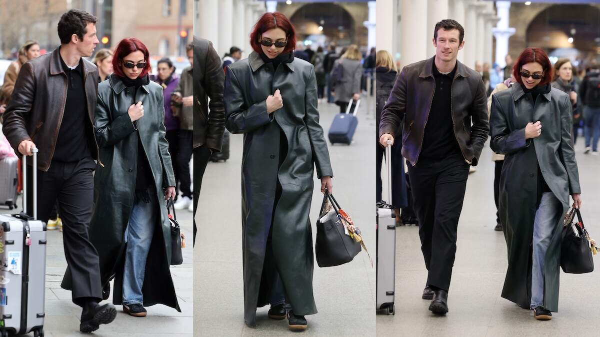 Singer Dua Lipa and Callum Turner walk through a London train station wearing black outfits