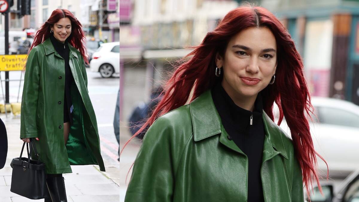 Singer Dua Lipa wears a green trench coat while walking a London street