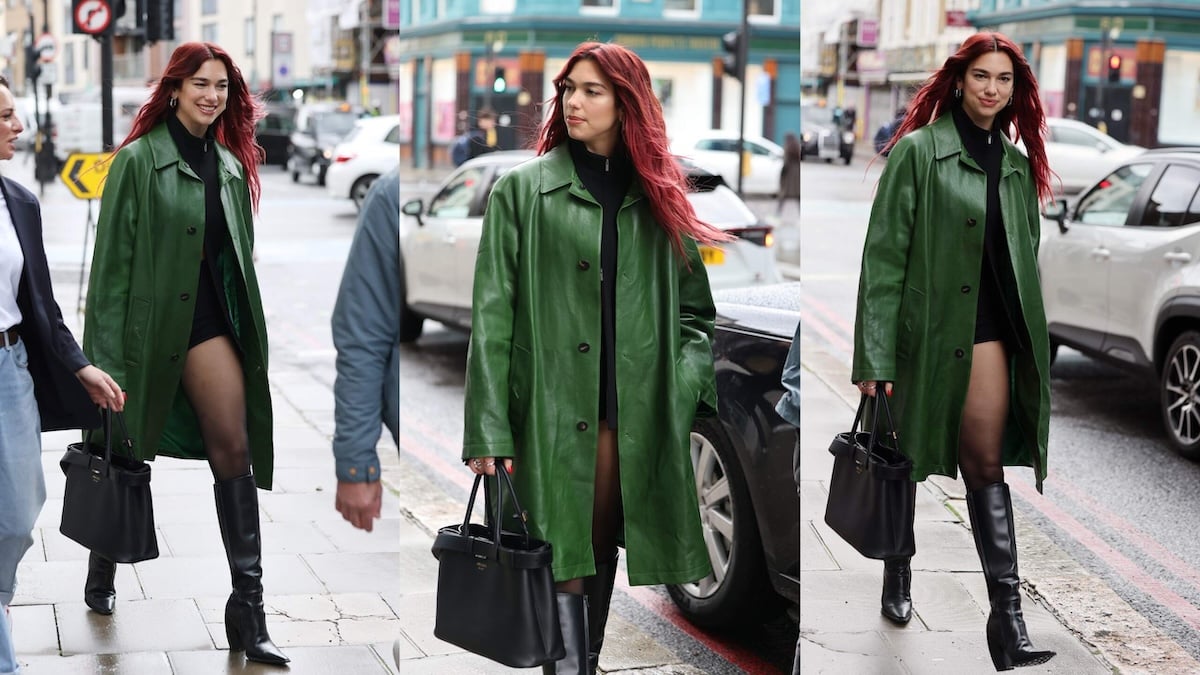 Singer Dua Lipa wears a green trench coat while walking a London street