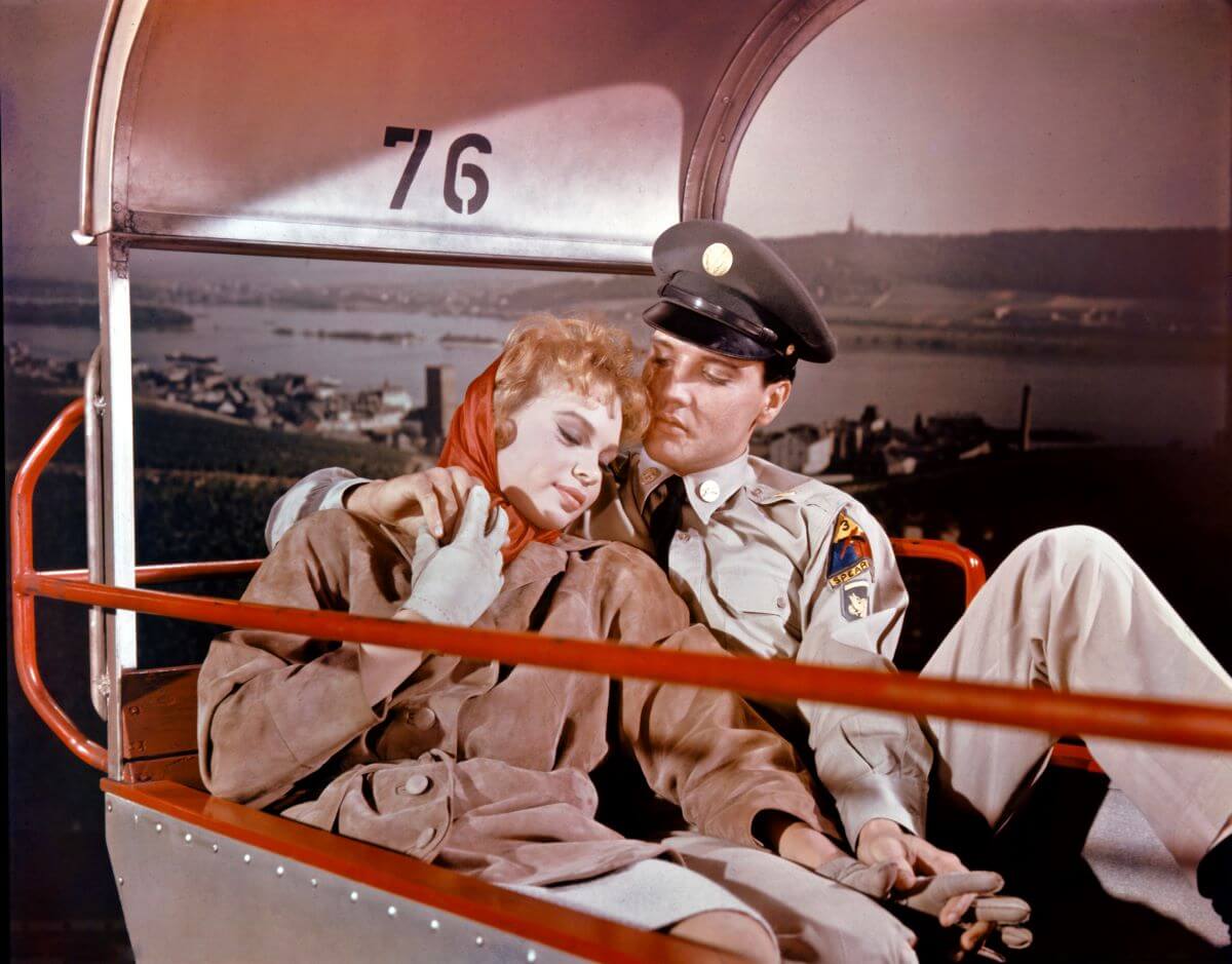 Elvis sits with his arm around Juliet Prowse on the set of 'G.I. Blues.'