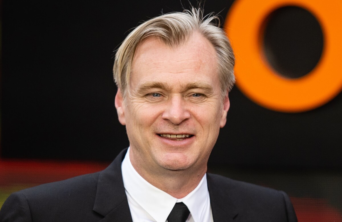 Christopher Nolan posing at the premiere of 'Oppenheimer' in a suit.