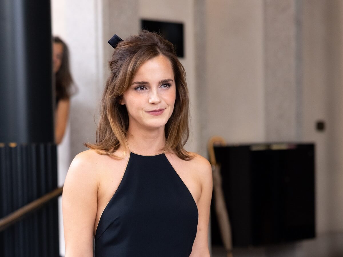 Emma Watson posing in a black dress at the Milan Fashion Week - Womenswear Spring/Summer 2024.