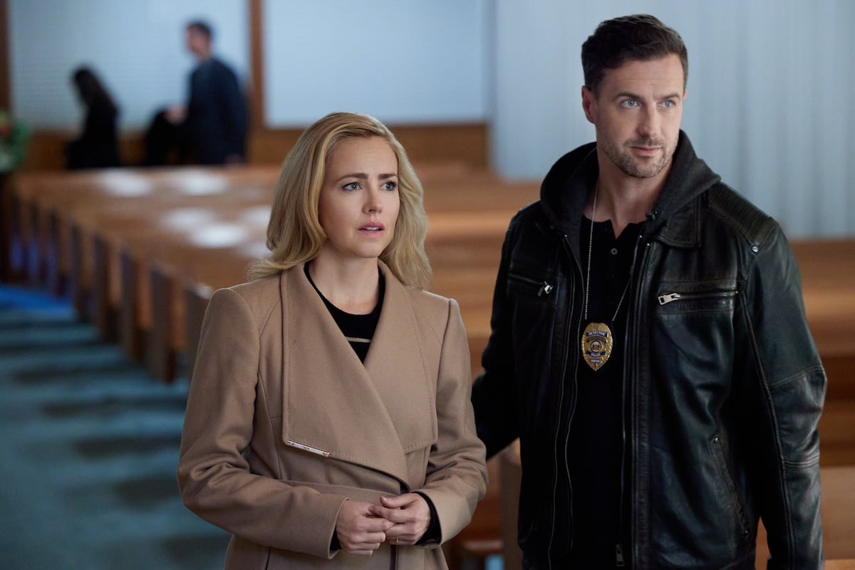 Amanda Schull and Brendan Penny standing in a church in Hallmark's 'Family Practice Mysteries: Coming Home'