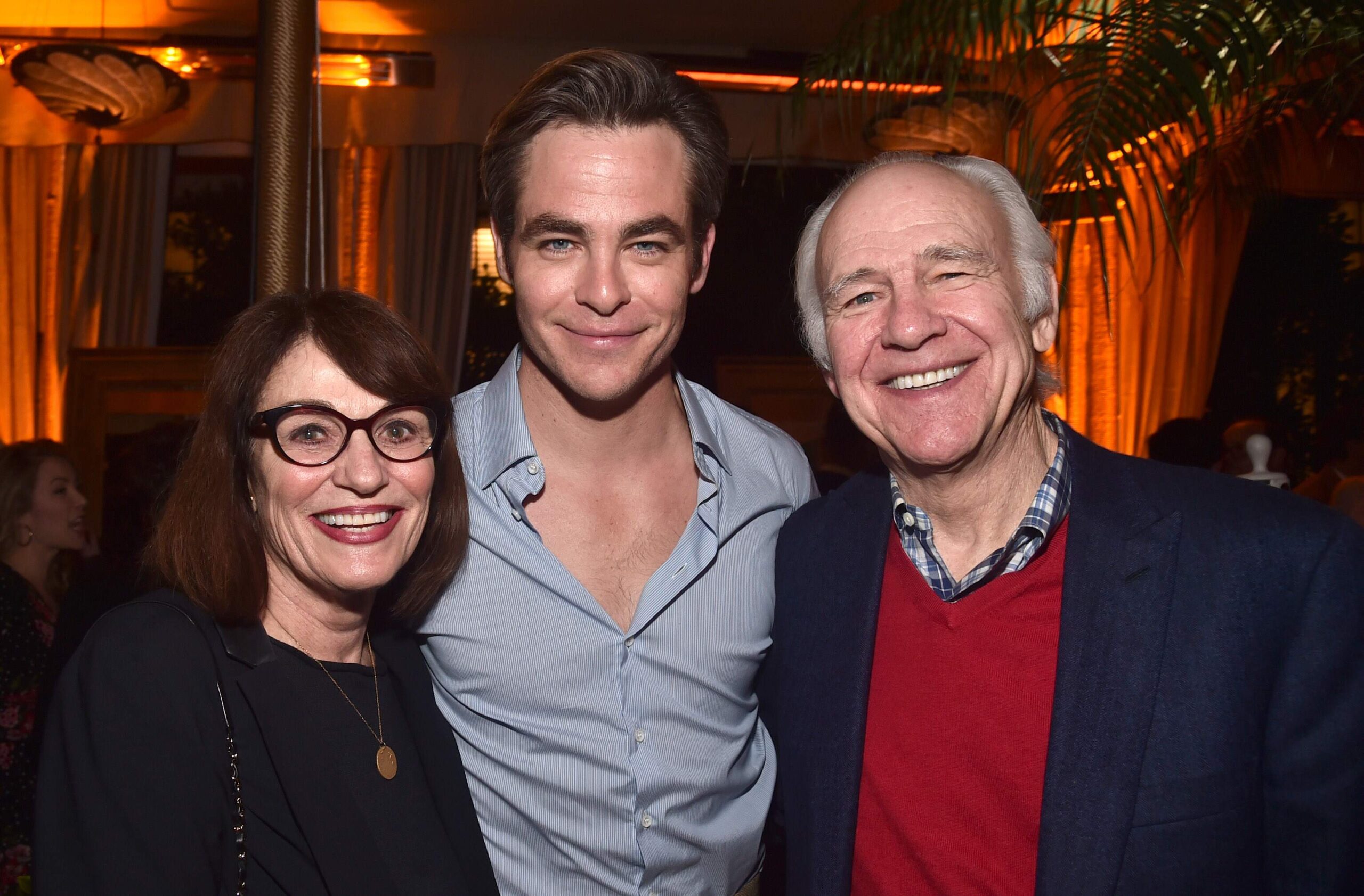 Chris Pine and his parents smile together at a TV series premiere in 2019