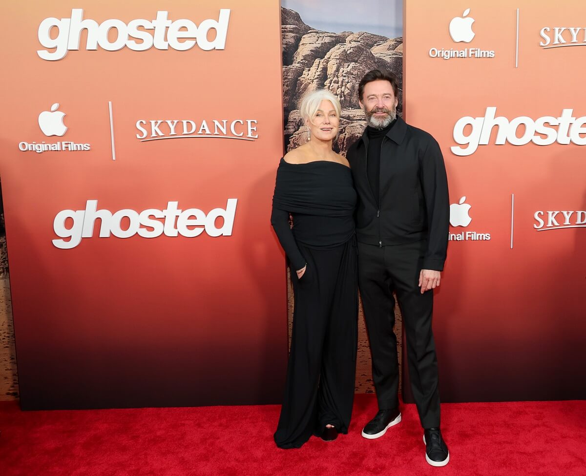 Deborra-Lee Furness and Hugh Jackman posing at the Apple Original Films' "Ghosted" in matching outfits.
