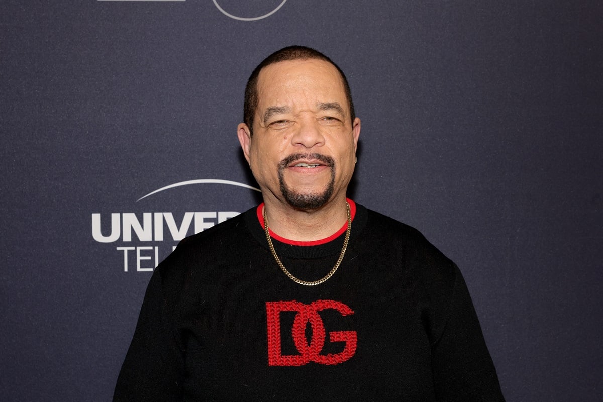 Ice-T posing at the "Law & Order: Special Victims Unit" 25th anniversary celebration in a black and red sweater.