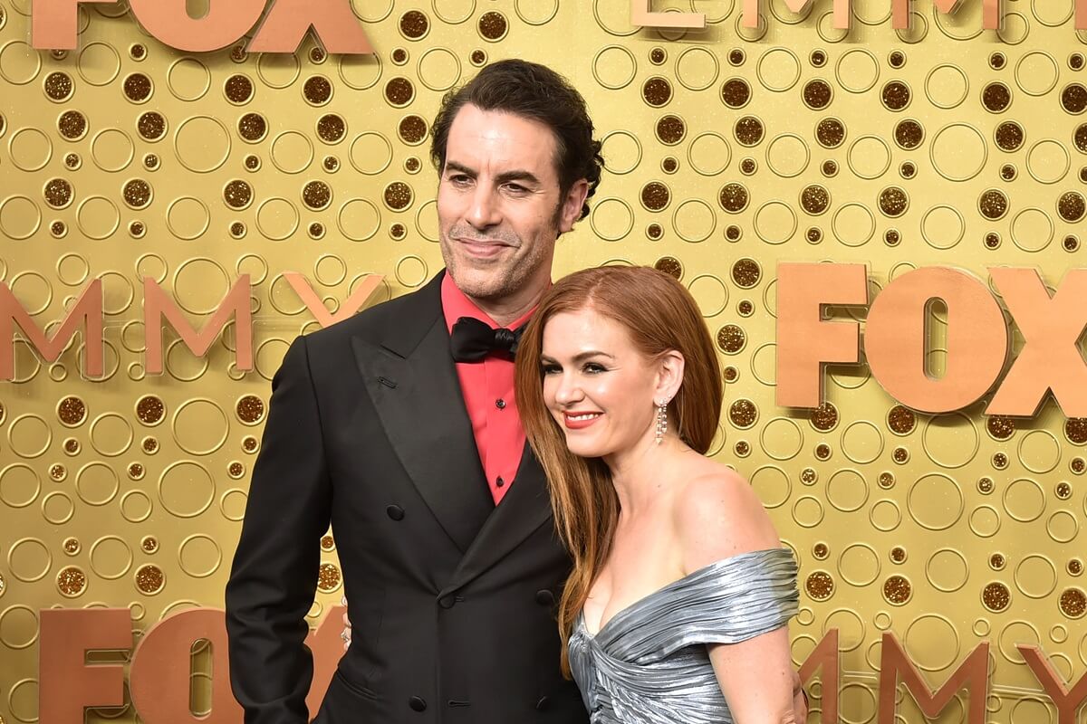 Sacha Baron Cohen and Isla Fisher attend the 71st Emmy Awards in a suit and dress.