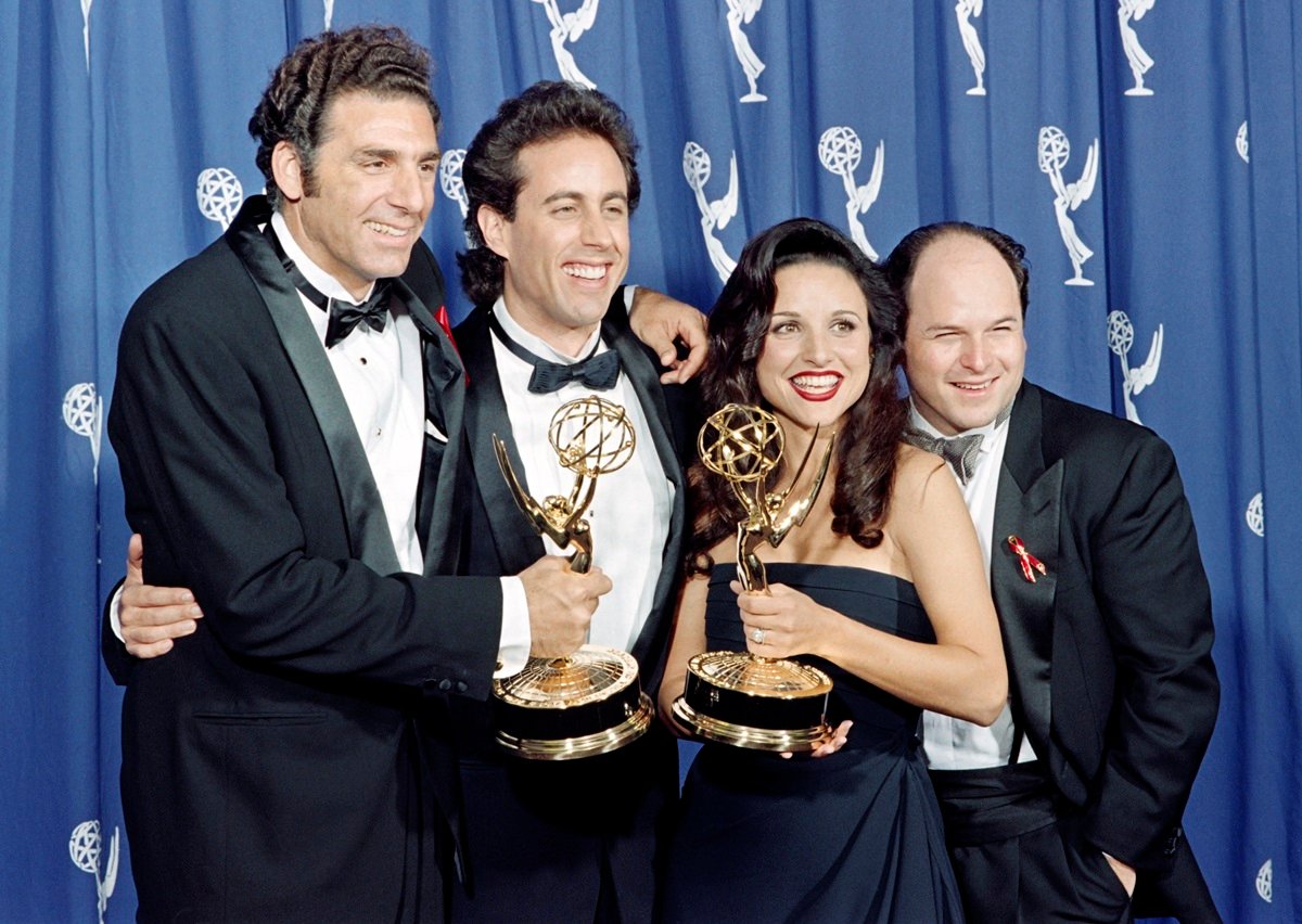 Jason Alexander, Jerry Seinfeld, Julia Louis-Dreyfus and Michael Richards all posing at the Primetime Emmy Awards with their awards.