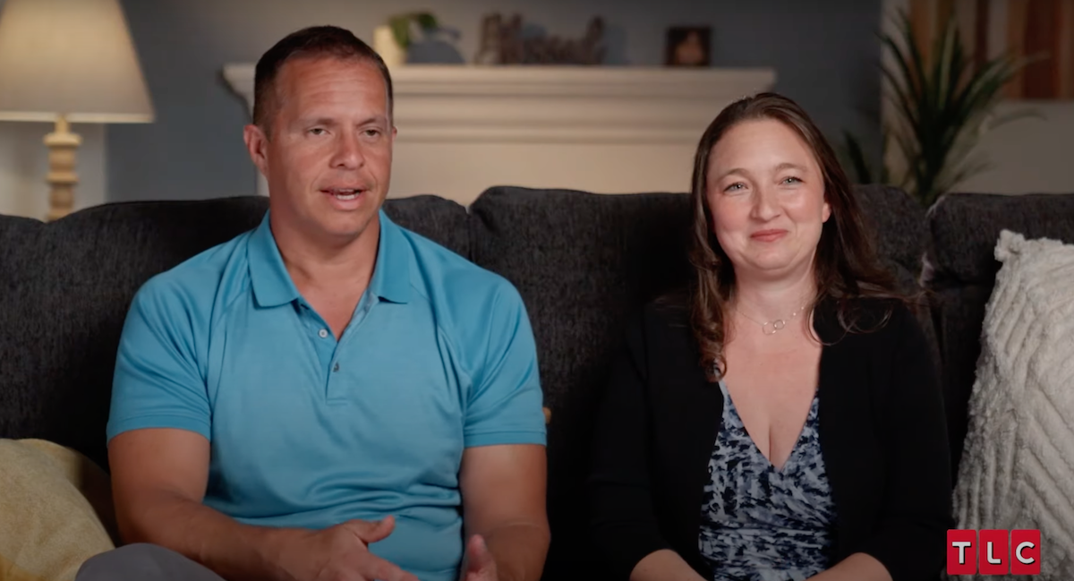 Justin and Becky Ryan sitting on a couch in an episode of 'Seeking Sister Wife'