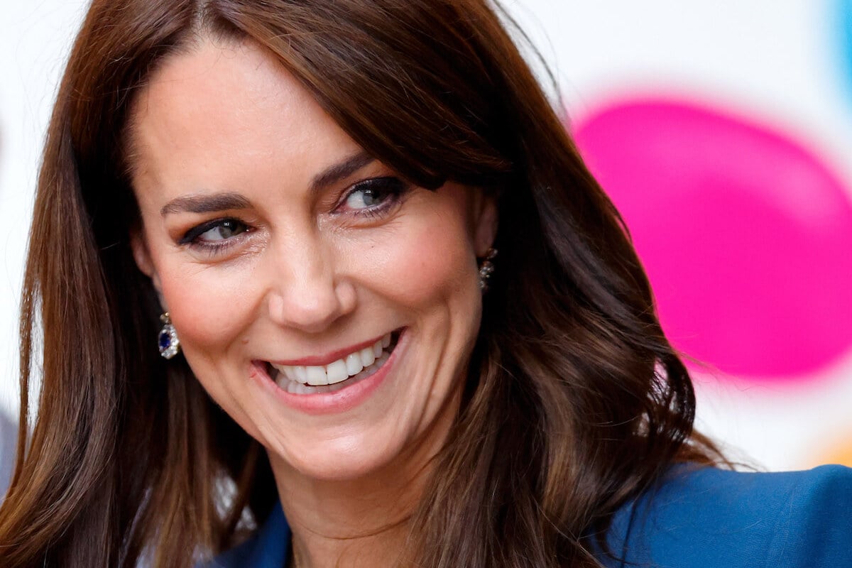 Kate Middleton, who avoids wearing orange, dark brown, and purple, smiles wearing blue