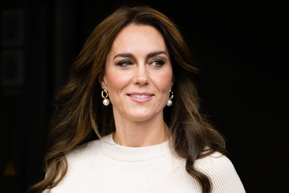 Kate Middleton, who said 'everyone teases' her in the royal family about walkabouts, looks on wearing white