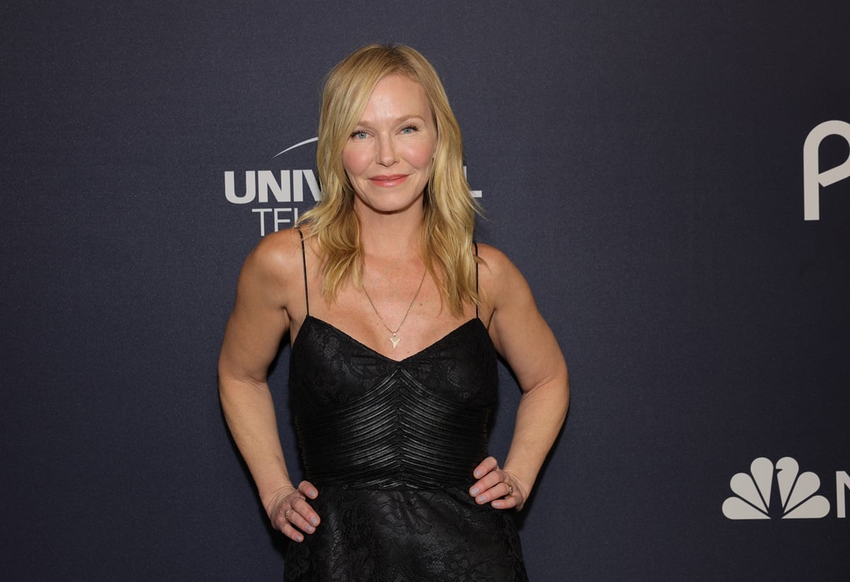 Kelli Giddish posing while wearing a black dress at the 'Law & Order SVU' 25th anniversary special.