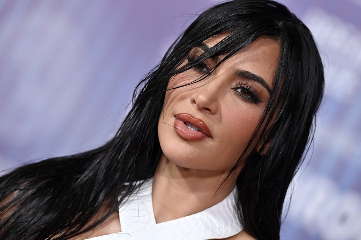 Kim Kardashian posing in a white dress at the 10th Annual Breakthrough Prize Ceremony.