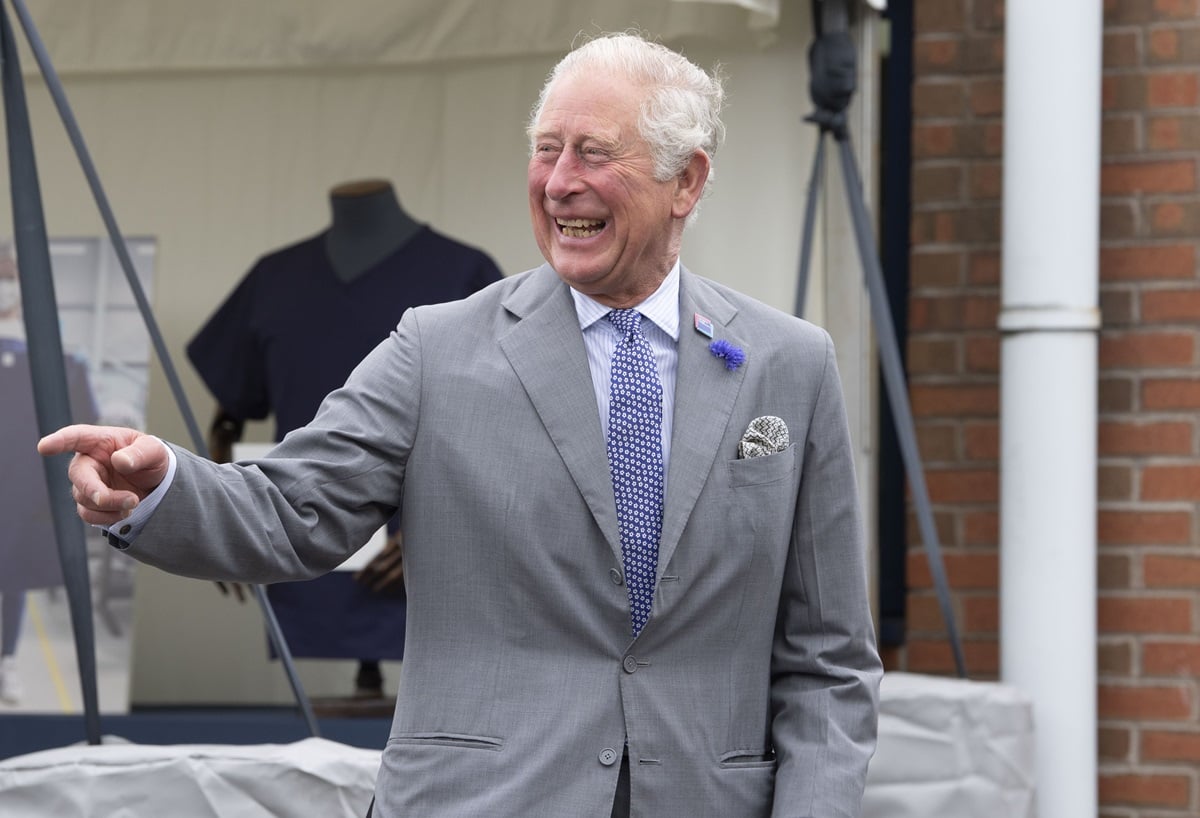 King Charles III laughing during a visit to the Turnbull & Asser shirt factory in Gloucester, England
