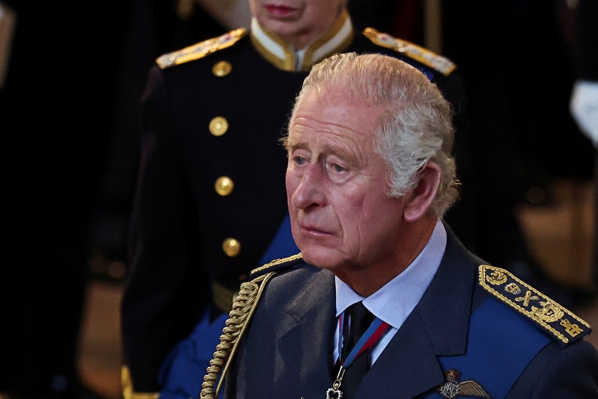 King Charles III walks as procession with the coffin of Queen Elizabeth II arrives at Westminster Hall from Buckingham Palace
