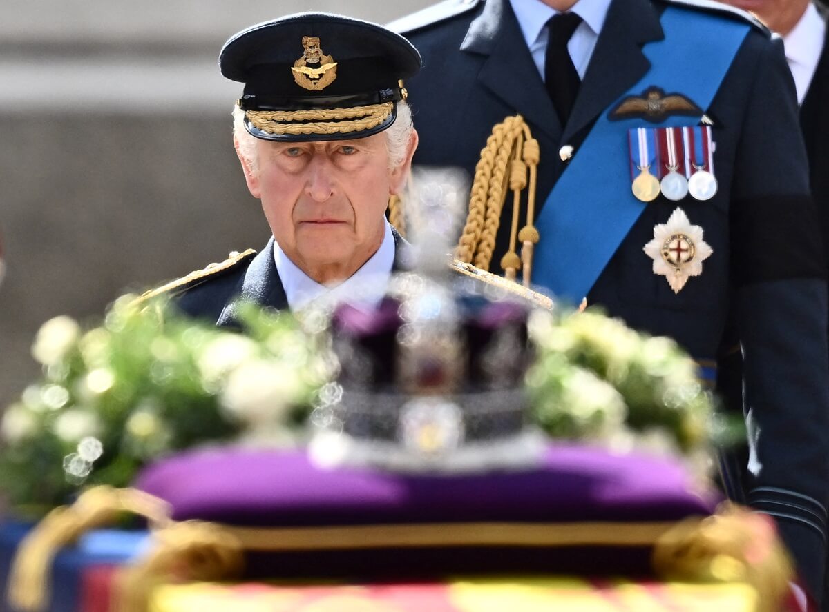 King Charles III walks behind the coffin of Queen Elizabeth II
