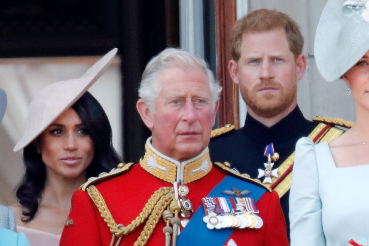 King Charles, who may invite Prince Harry and Meghan Markle to Balmoral this summer, with his son and daughter-in-law stand on the Buckingham Palace balcony
