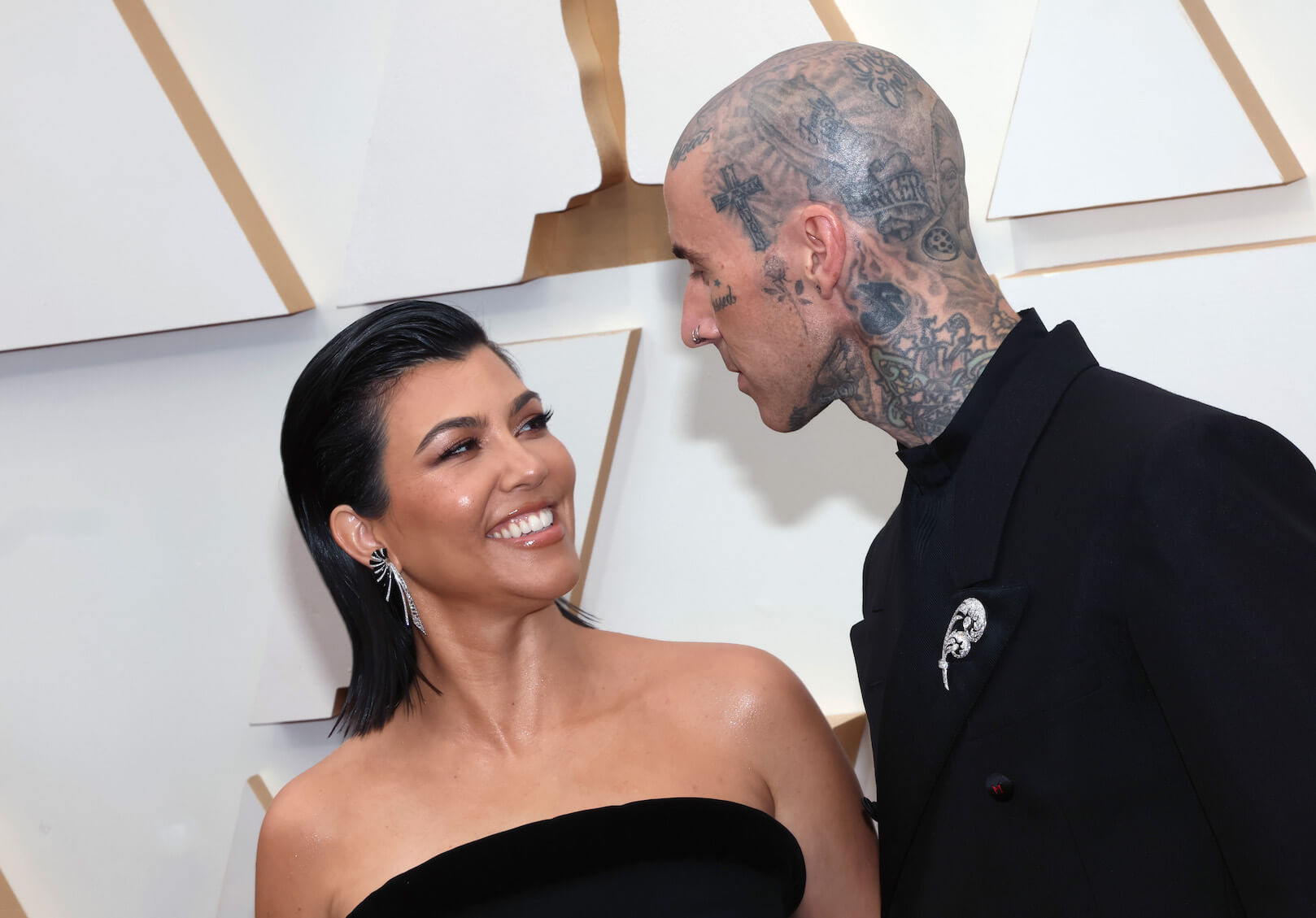 Kourtney Kardashian smiling at Travis Barker at the Academy Awards in 2024