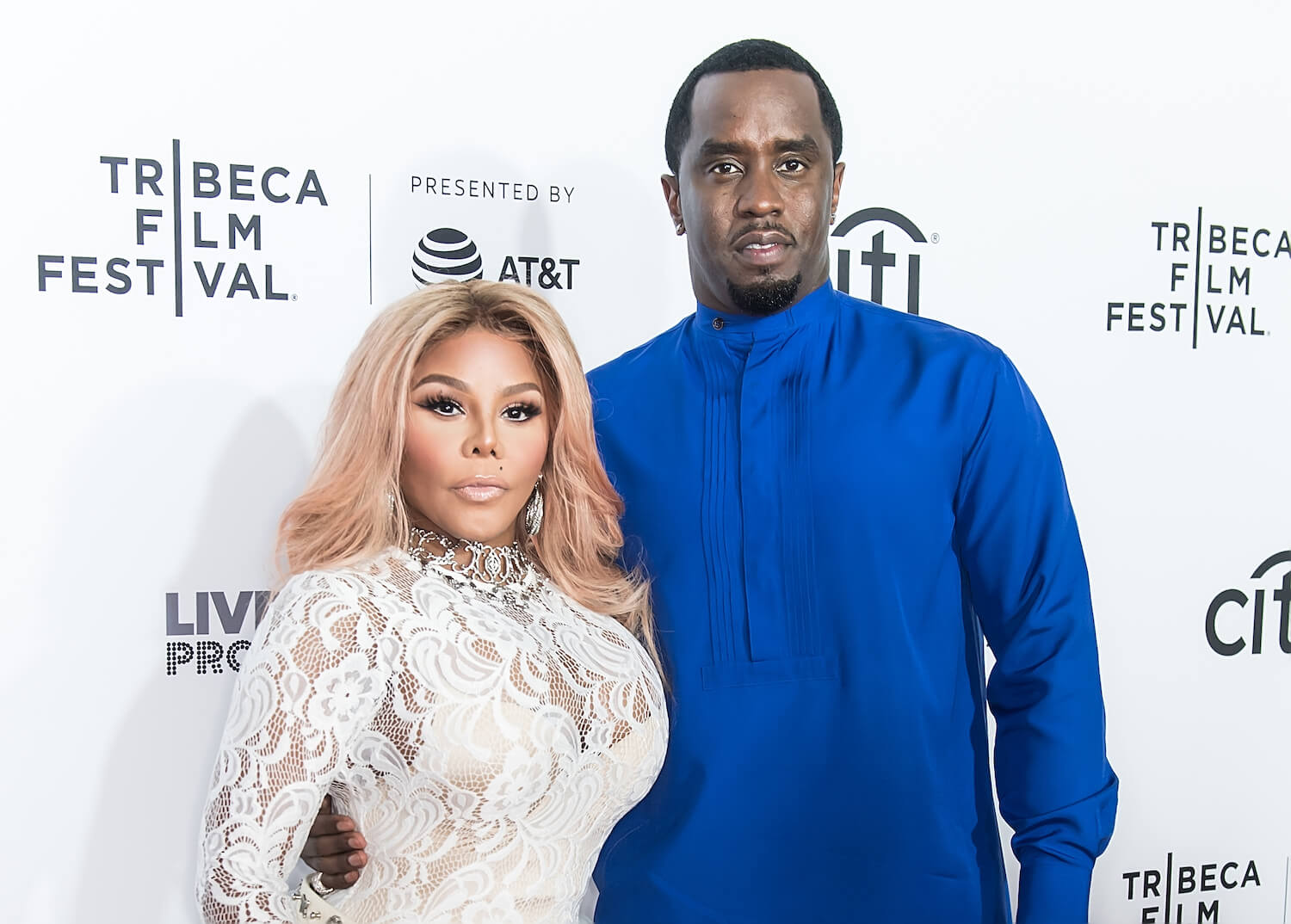 Lil' Kim and Sean 'P. Diddy' Combs side hugging at Tribeca Film Festival