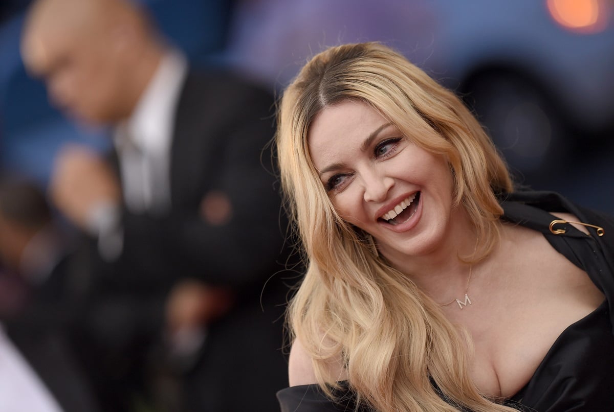 Madonna smiling in a black dress at the 'China: Through The Looking Glass' Costume Institute Benefit Gala.