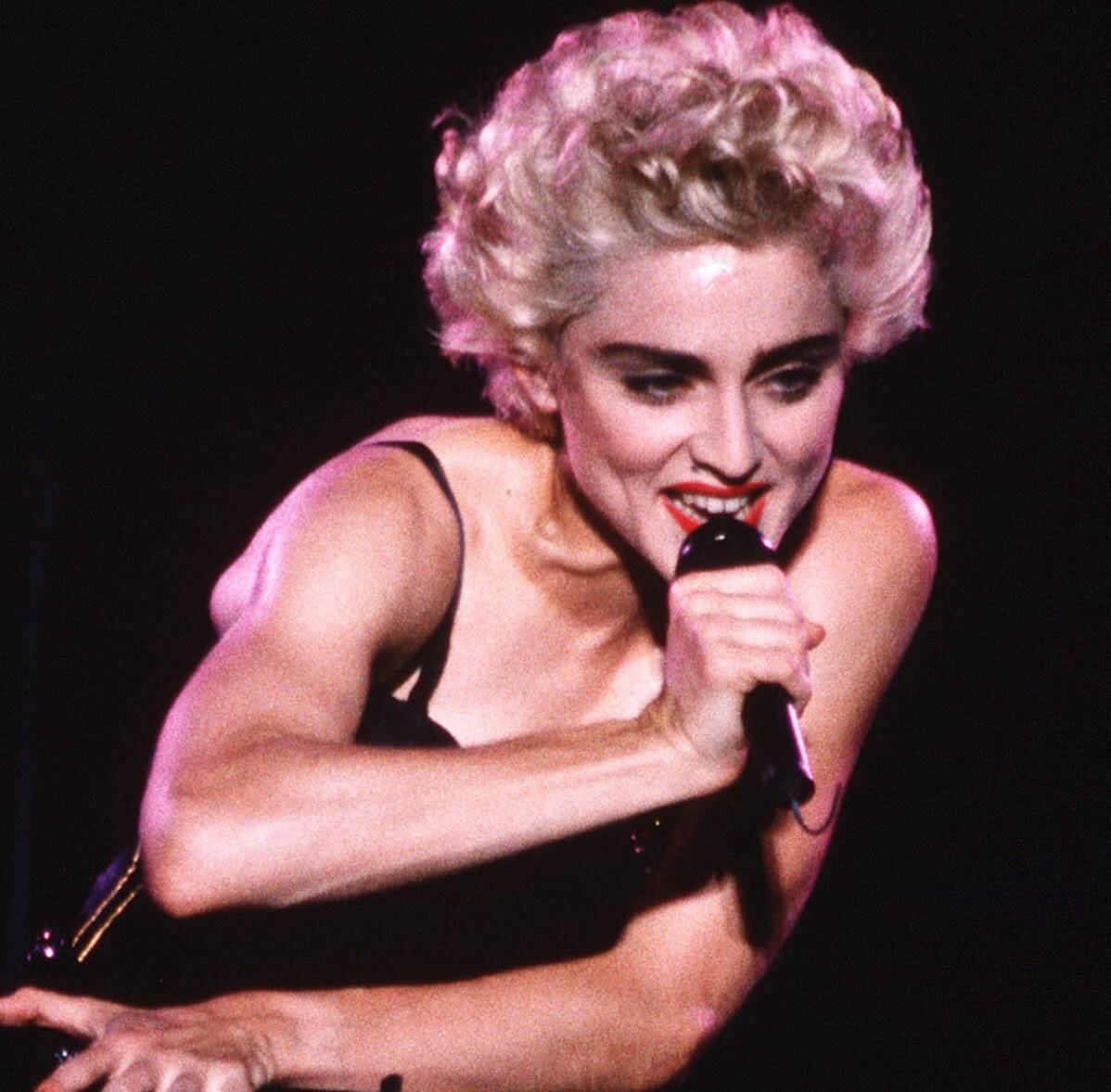 "Holiday" singer Madonna with a microphone