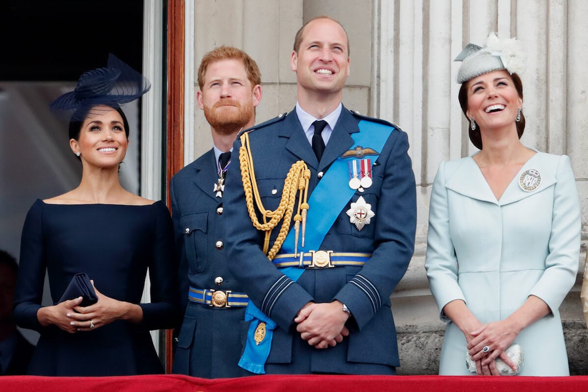 Meghan Markle, who reportedly thinks Prince Harry's making a mistake by reaching out to Prince William, with Prince William and Kate Middleton on the Buckingham Palace balcony.