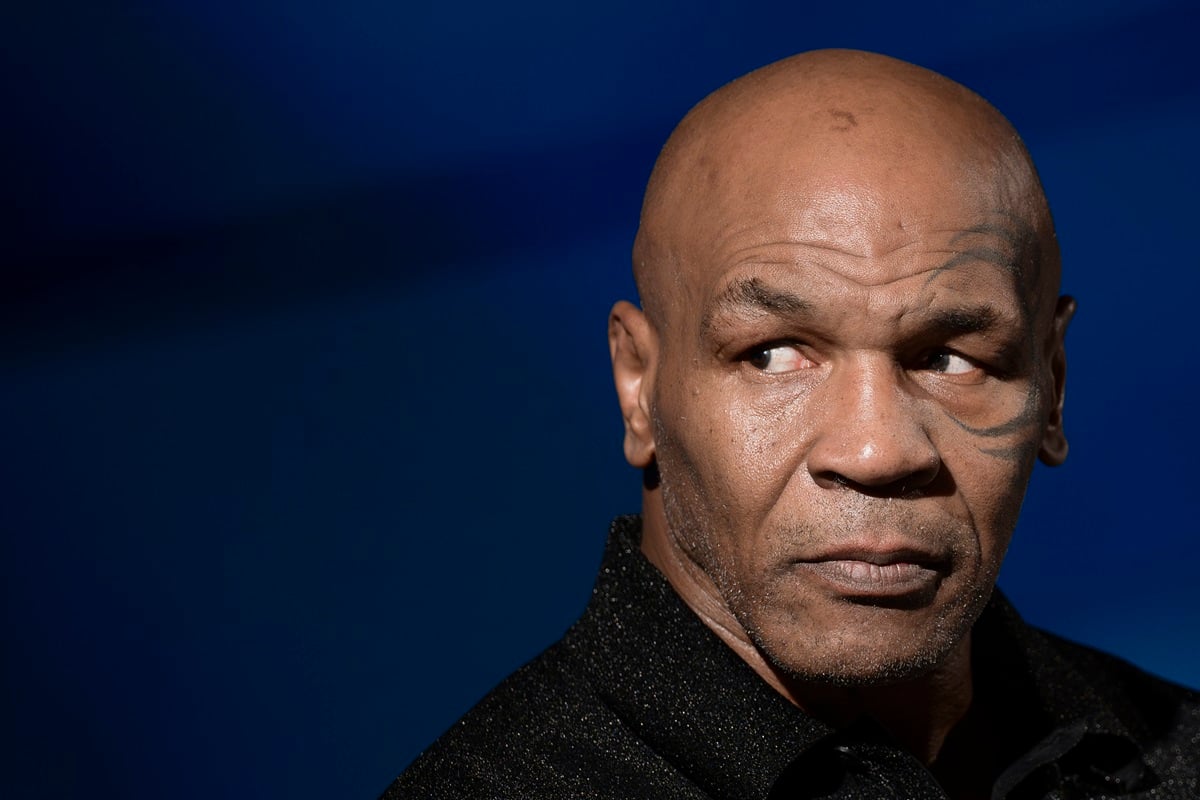 Mike Tyson posing in a black shirt at a press conference for 'Bunny-Man' film.