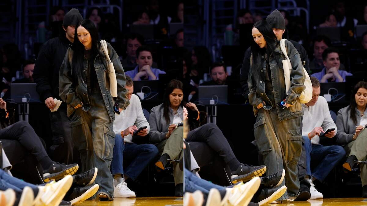 Pinkus and Noah Cyrus walk to their seats before a Lakers game