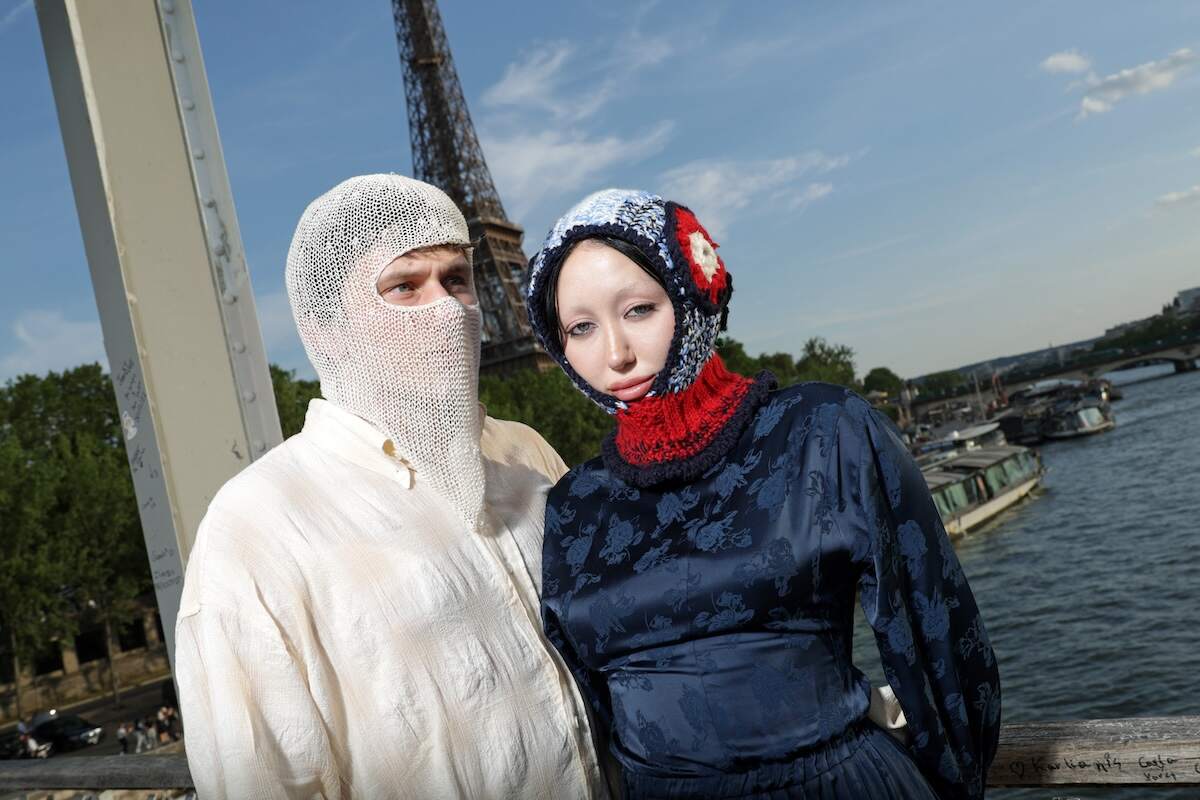 Engaged couple Pinkus and Noah Cyrus stand on a bridge over the Seine River in Paris, France