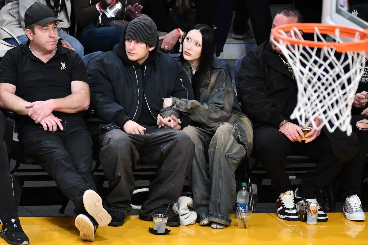 Pinkus and Noah Cyrus sit together courtside at a Lakers game with their hands on each others' legs