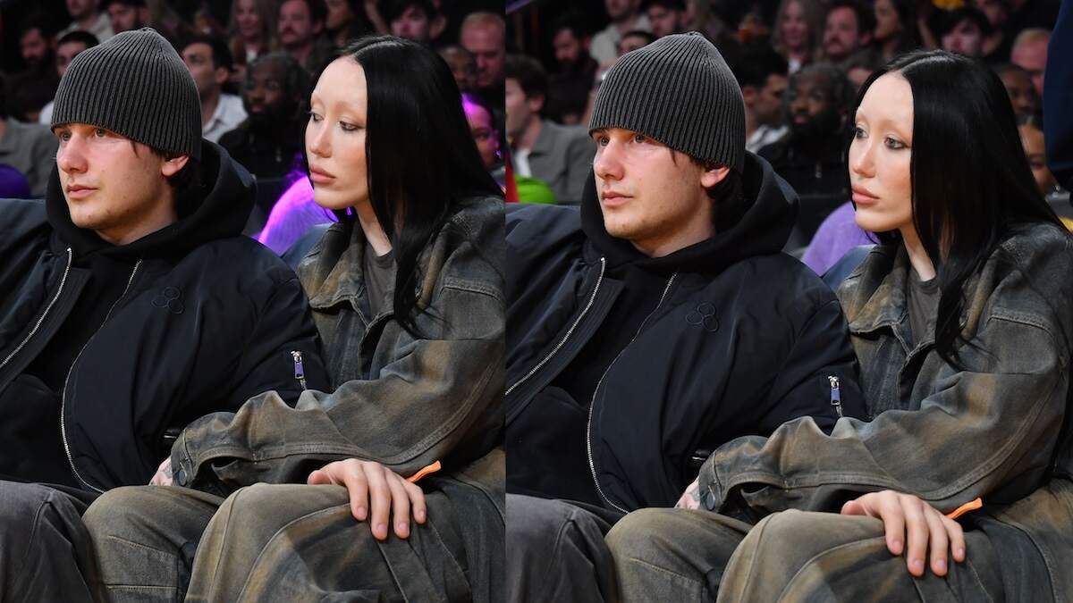 Pinkus and Noah Cyrus sit together courtside at a Lakers game with their hands on each others' legs