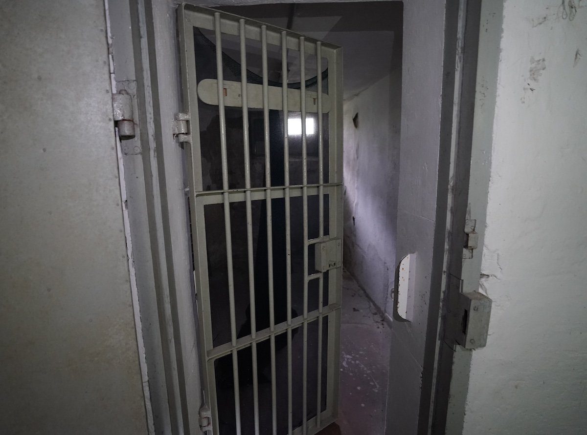 An open jail cell door