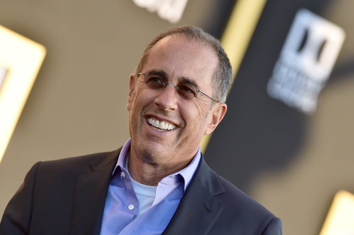 Jerry Seinfeld attends the premiere of Warner Bros. Pictures' 'A Star Is Born' in a suit and glasses.
