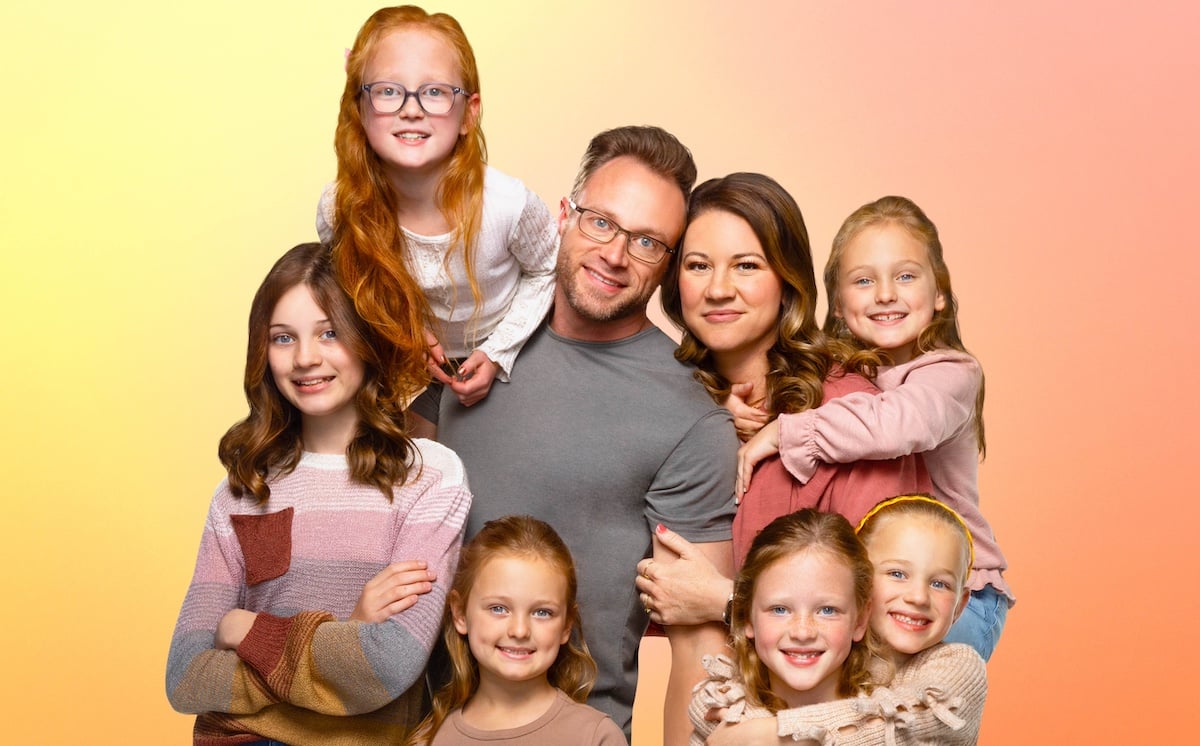 Group shot of the Busby family from 'OutDaughtered' on a yellow-orange background