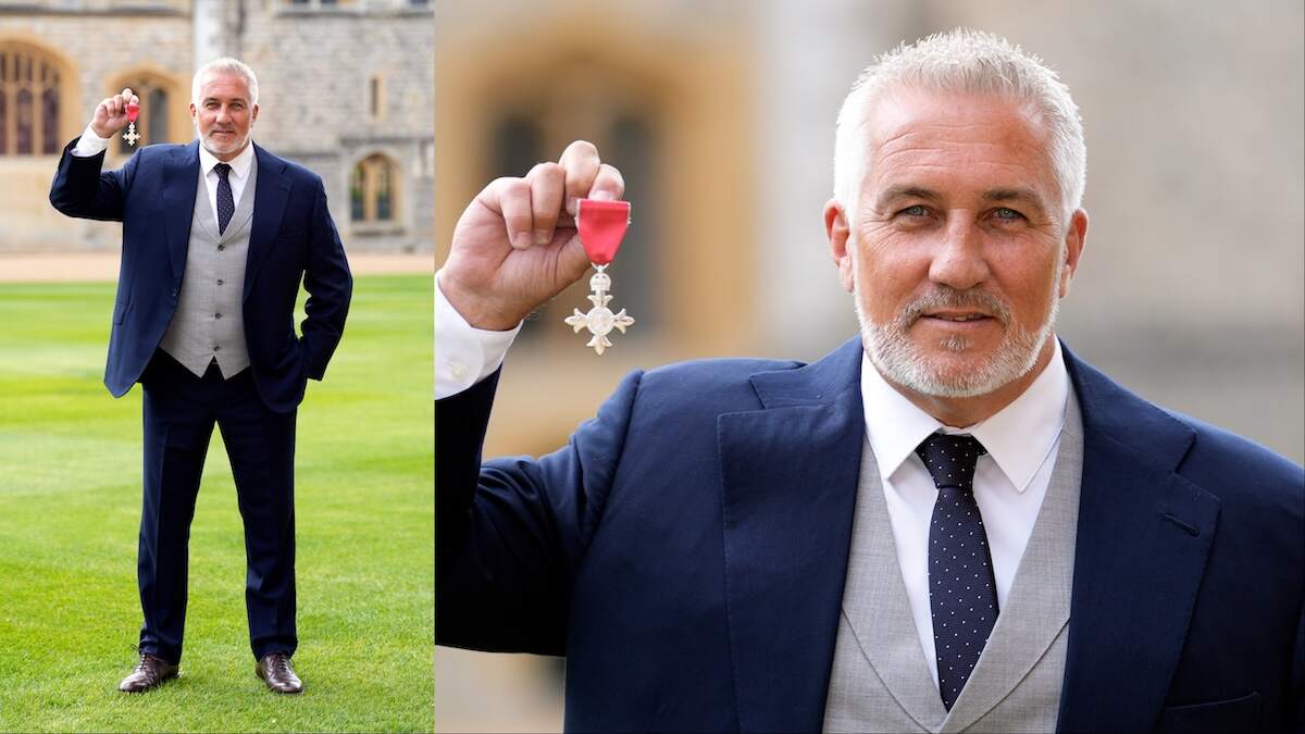 Celebrity chef Paul Hollywood holds up his medal after being made a Member of the Order of the British Empire