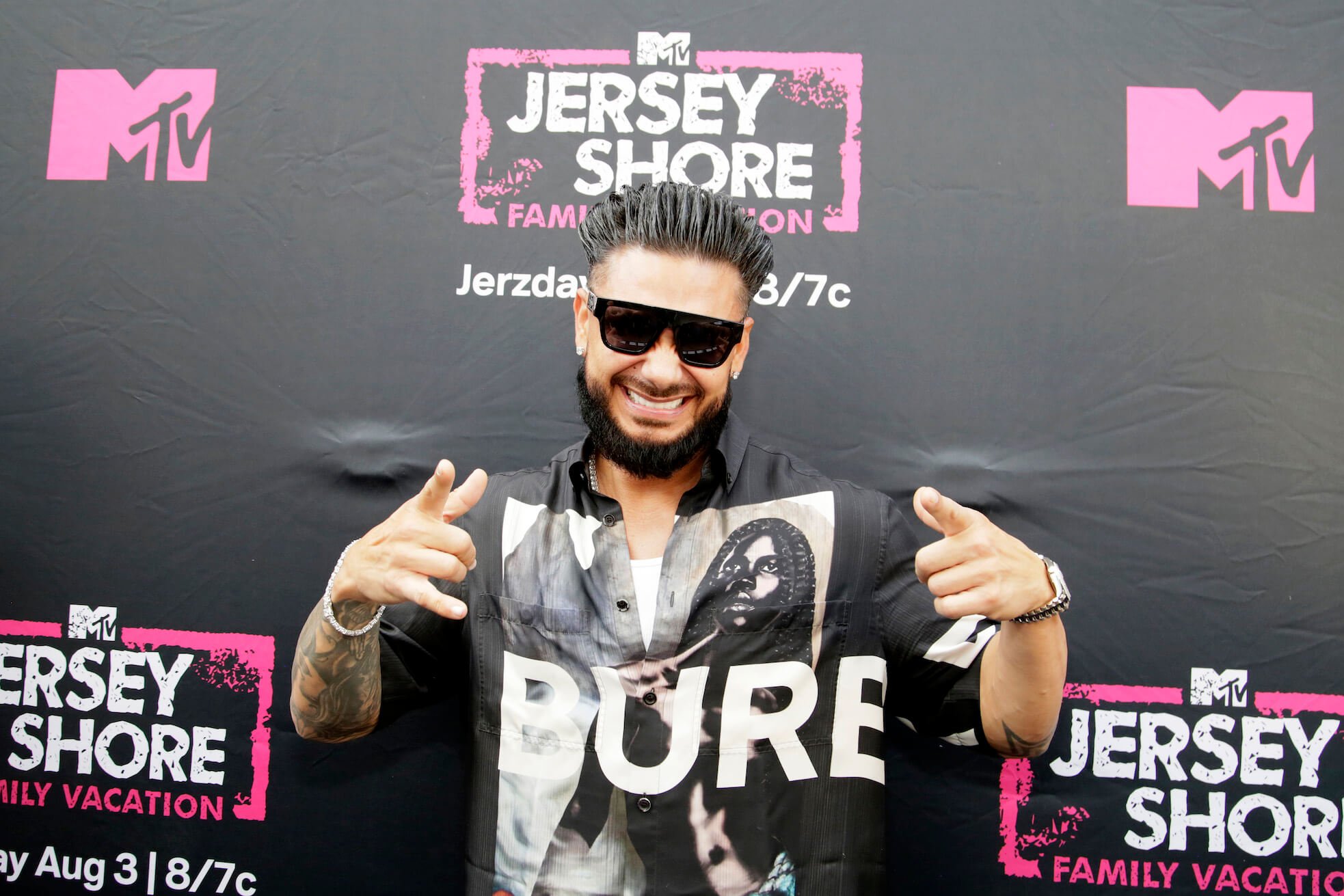'Jersey Shore: Family Vacation' Season 7 star DJ Pauly D smiling and gesturing at an MTV event