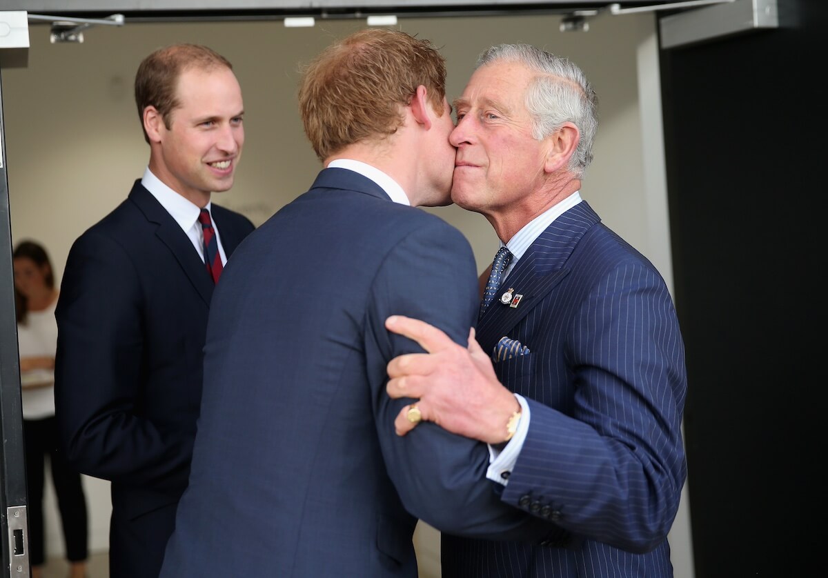 Prince Harry kisses King Charles on the cheek with Prince William