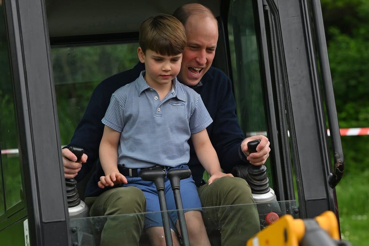 Prince William assisting Prince Louis as he uses an excavator while taking part in the Big Help Out