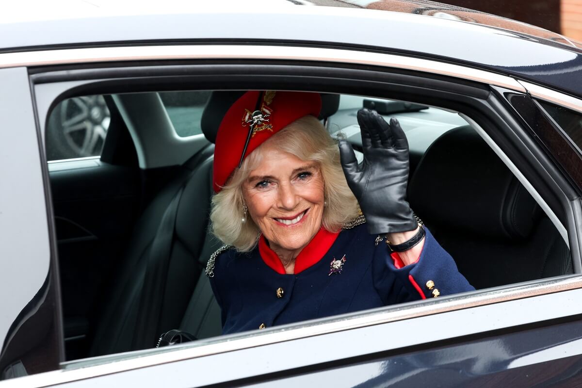 Queen Camilla smiles and waves as she departs from a visit to The Royal Lancers in Catterick, England