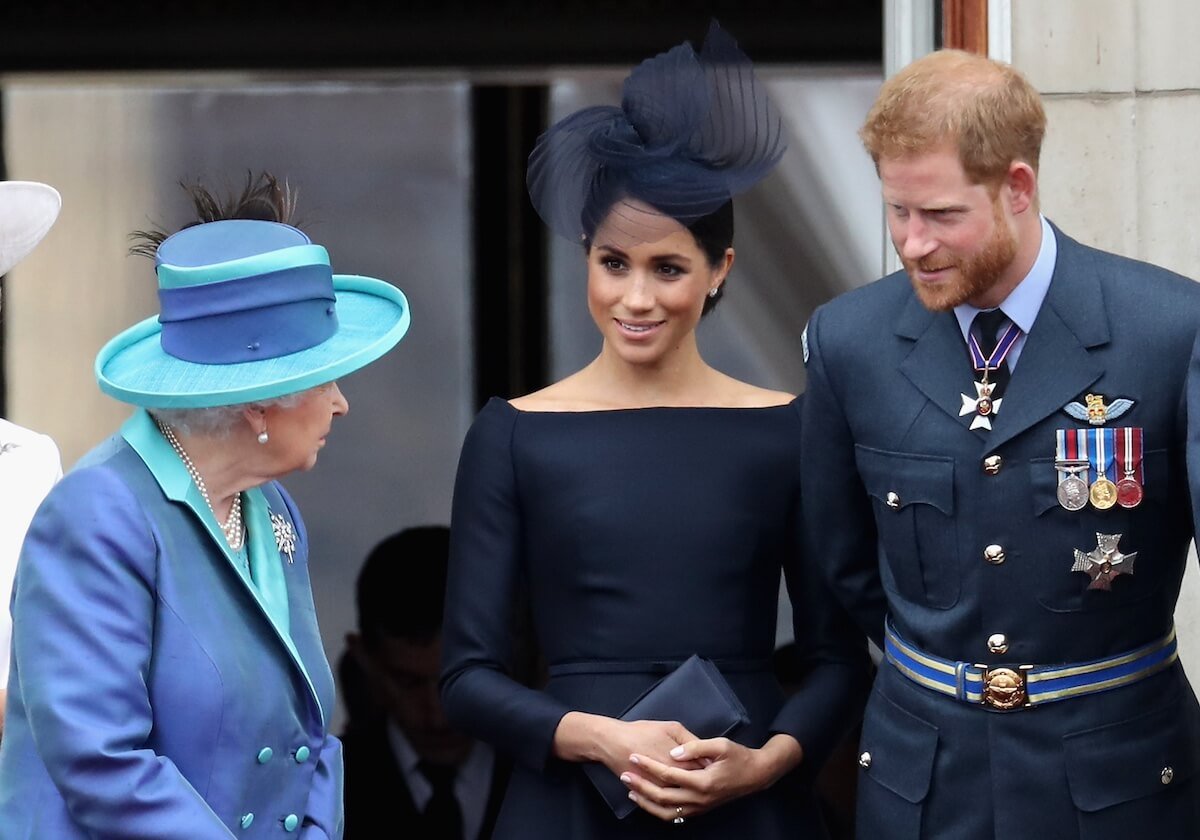 Queen Elizabeth chatting with Meghan Markle and Prince Harry in 2018