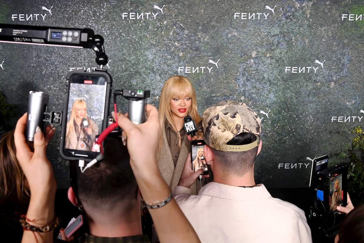 Singer Rihanna speaks into a microphone at the FENTY x PUMA Creeper Phatty Launch Party