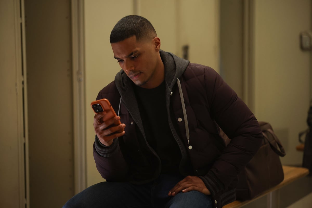 Gibson looking at his phone in 'Chicago Fire'
