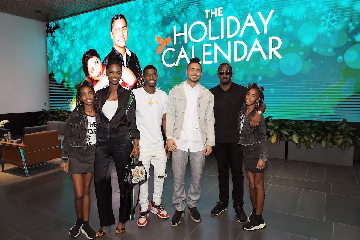 Diddy with his late partner Kim Porter and his children, Christian, Quincy, D'Lila, and Jessie smile together at a 2018 event