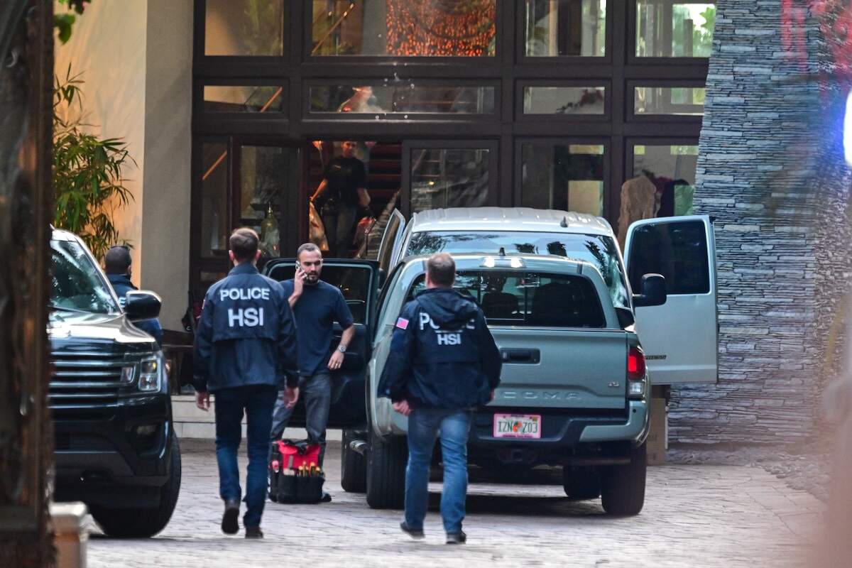 Agents are seen at the entrance of producer and musician Sean "Diddy" Combs's home at Star Island in Miami Beach