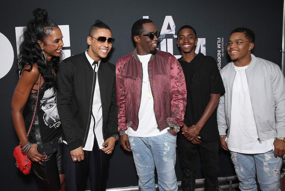 Diddy with his late partner Kim Porter and his sons, Quincy, Sean, Christian, and Justin, as the smile together on a red carpet in 2015