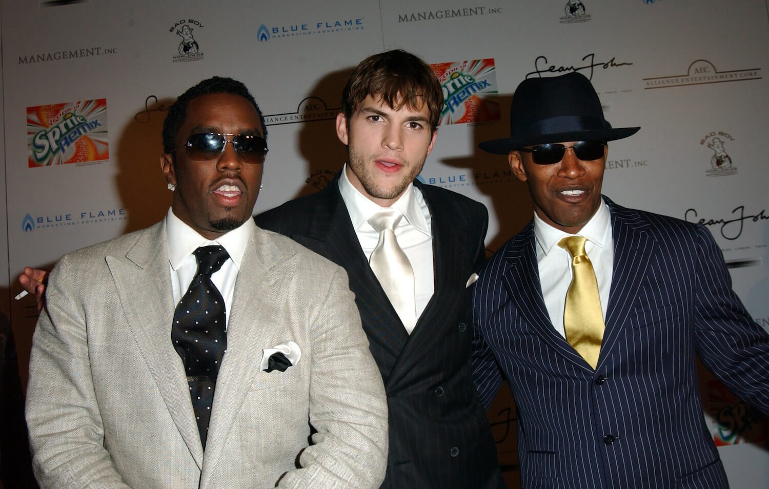 Sean 'P. Diddy' Combs, Ashton Kutcher, and Jamie Foxx posing together