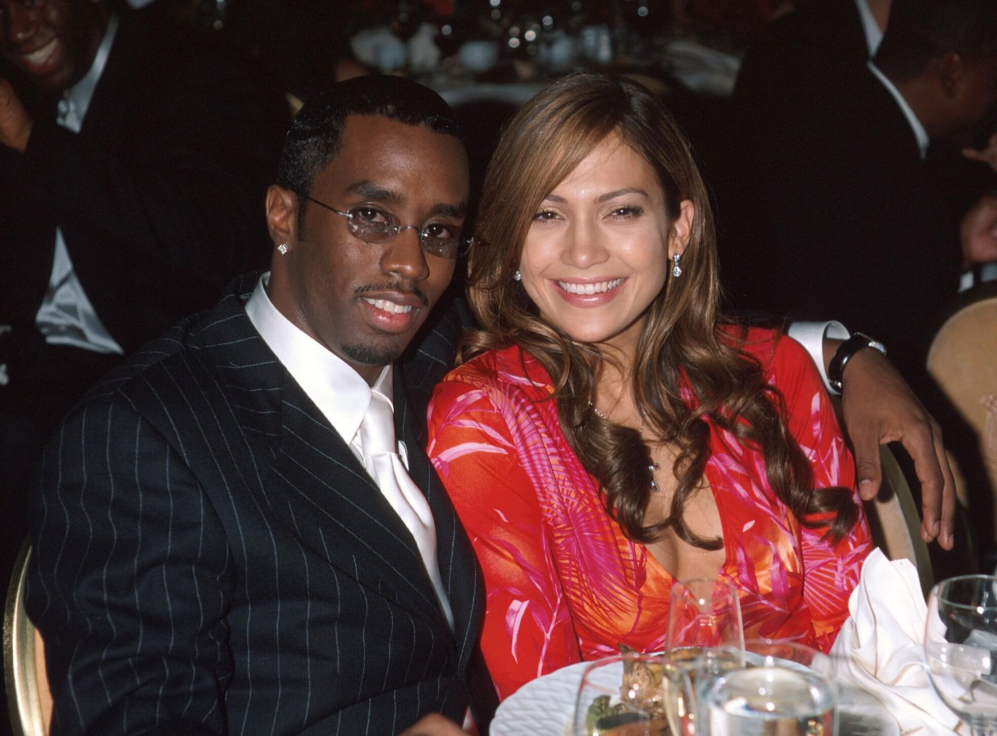Sean 'P. Diddy' Combs sitting next to Jennifer Lopez