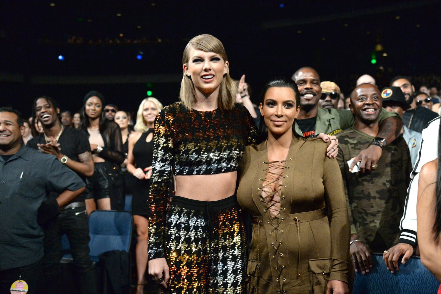 Taylor Swift and Kim Kardashian with their arms around each other in 2015