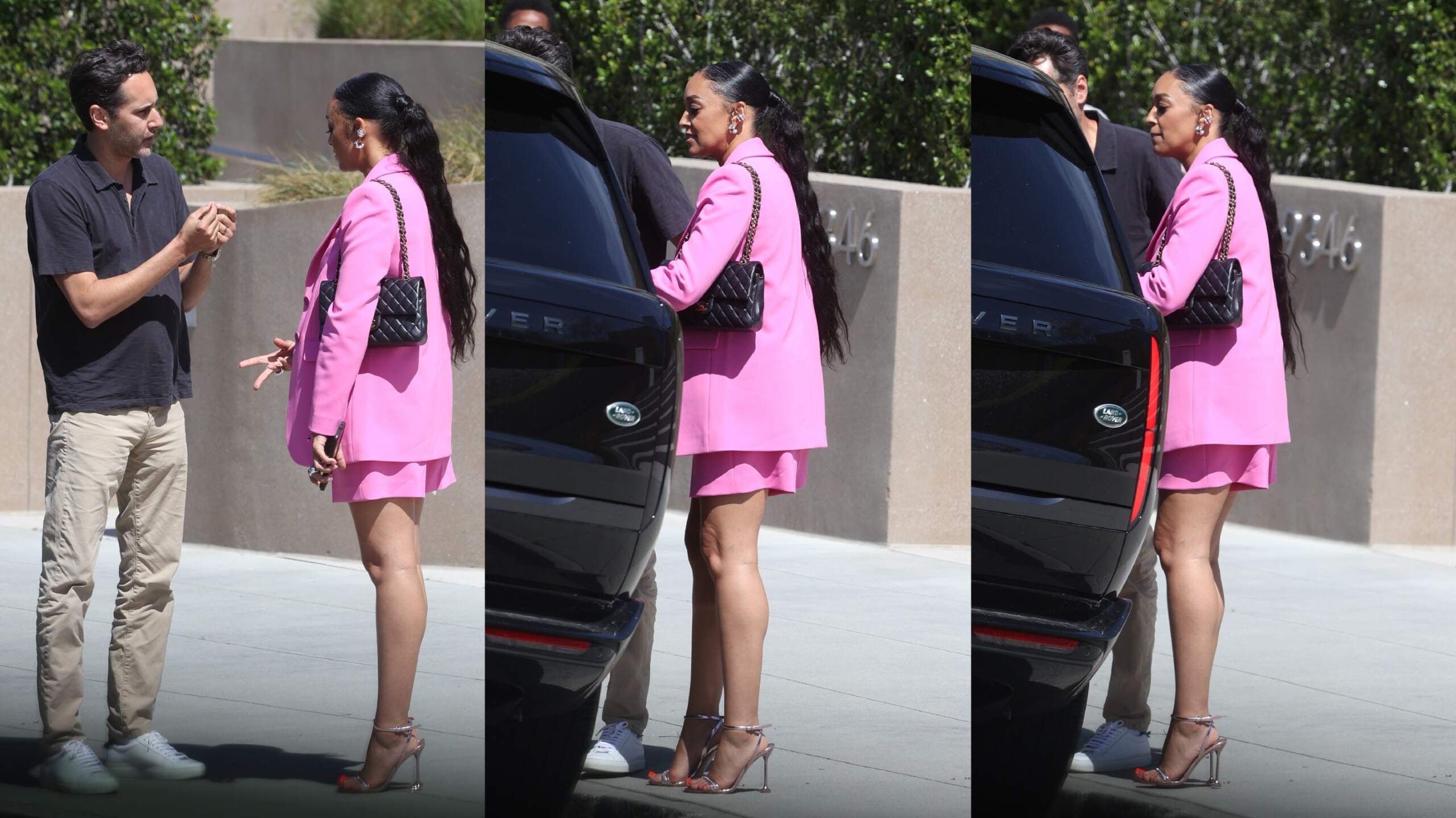 Wearing a pink blazer and matching skirt, Tia Mowry enters a black Range Rover