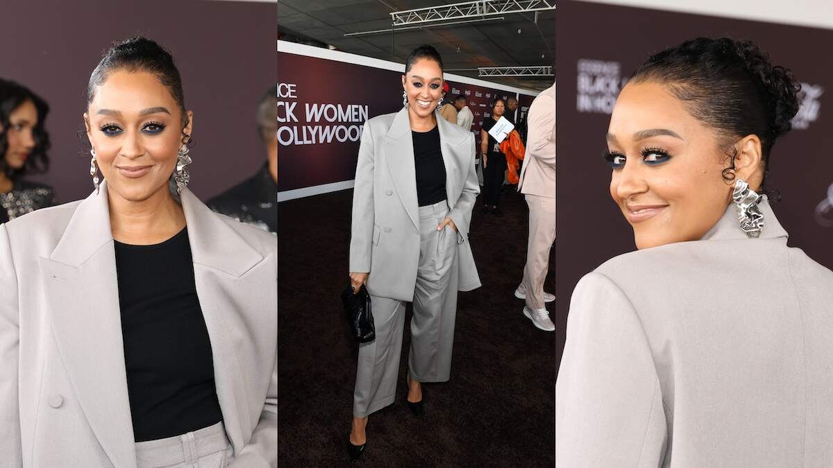 Wearing an oversized gray suit, Tia Mowry poses for photos at the ESSENCE Black Women In Hollywood Awards